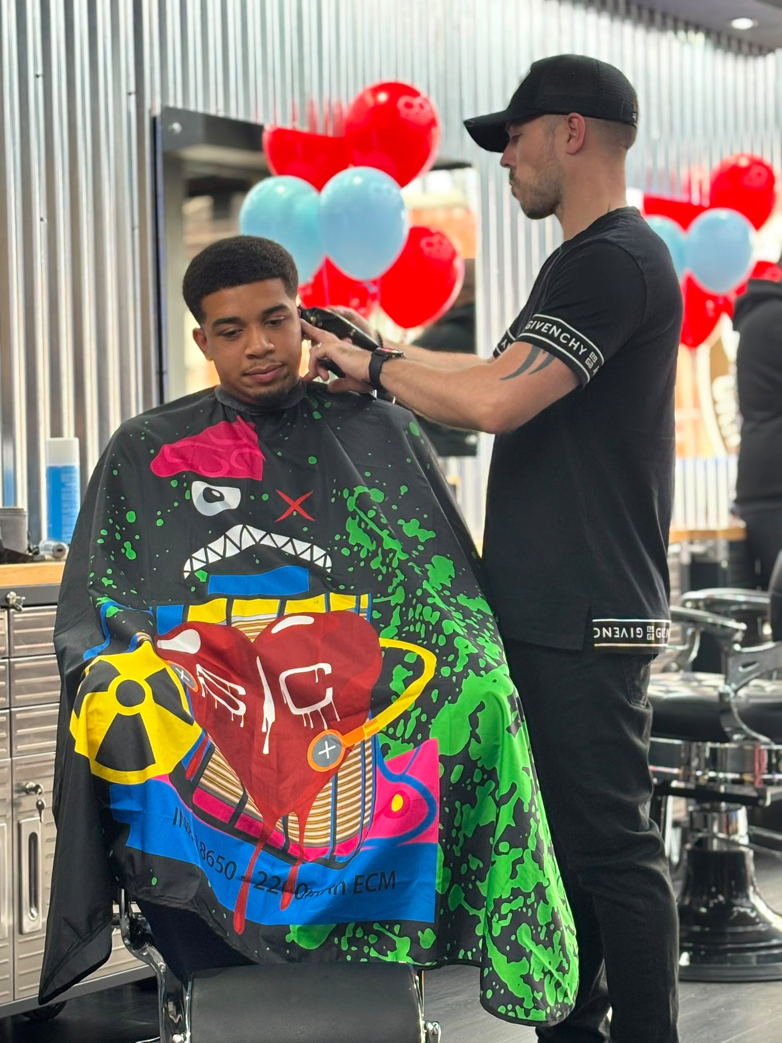 Grim edging a client's hairline with clippers in the Urmston shop